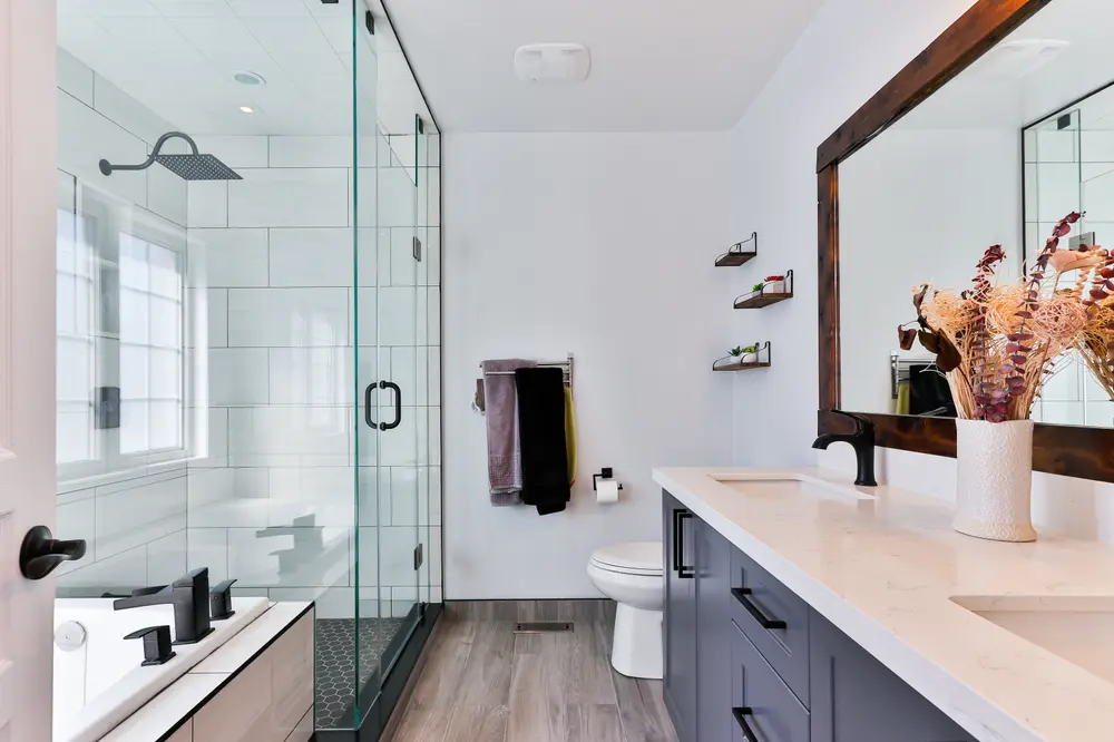 Bright bathroom with a glass shower and white tiles